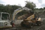 Phill cardy puting some of the old wall in to a dumper.